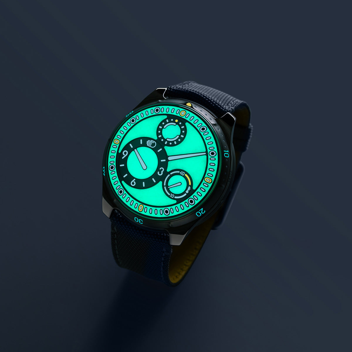 Angled luminous Ressence Type 5 L with mint green glowing dial and blue strap