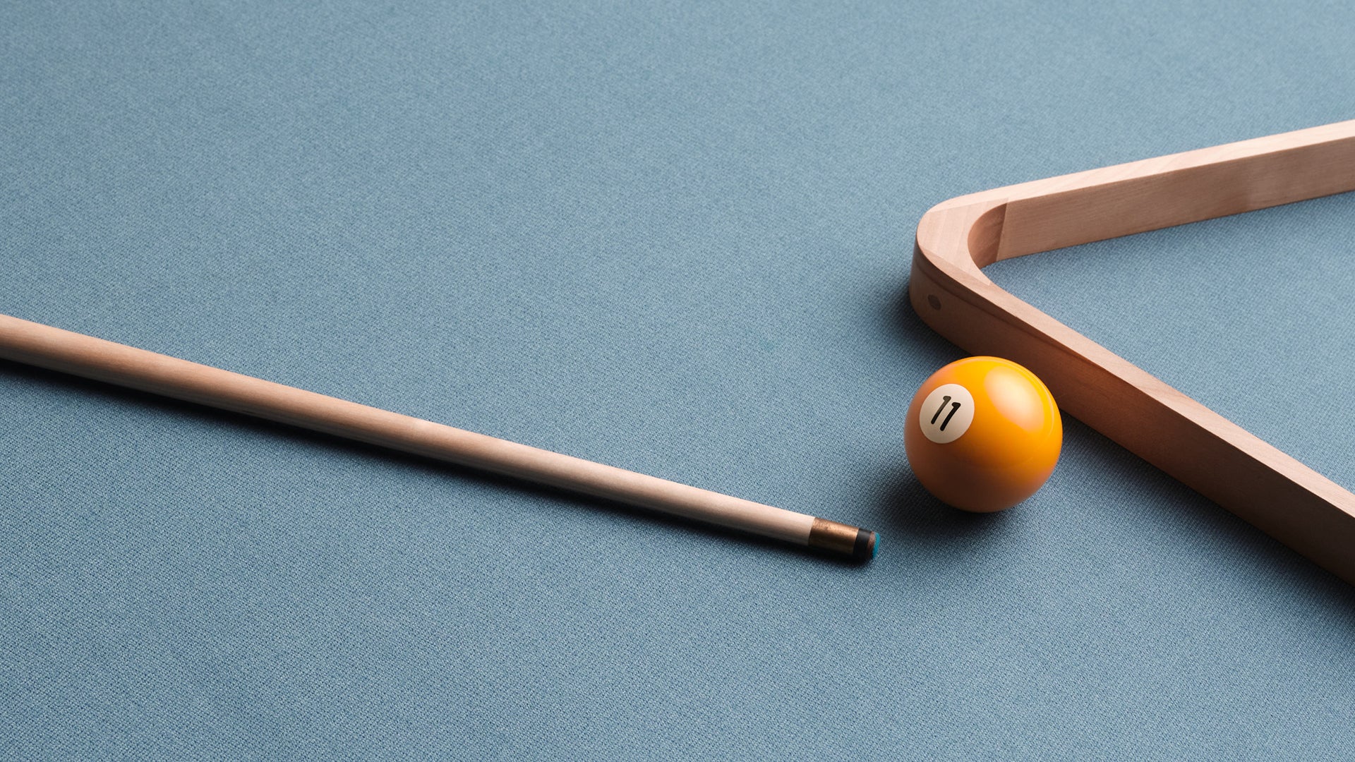 Pool cue and ball on a blue pool table