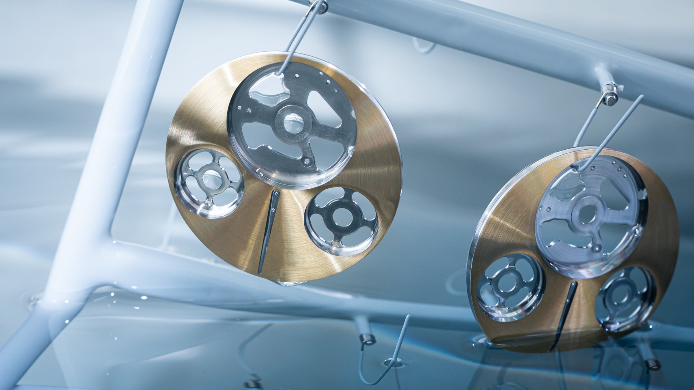 Ressence watches dial discs during the production process shown as exiting liquid