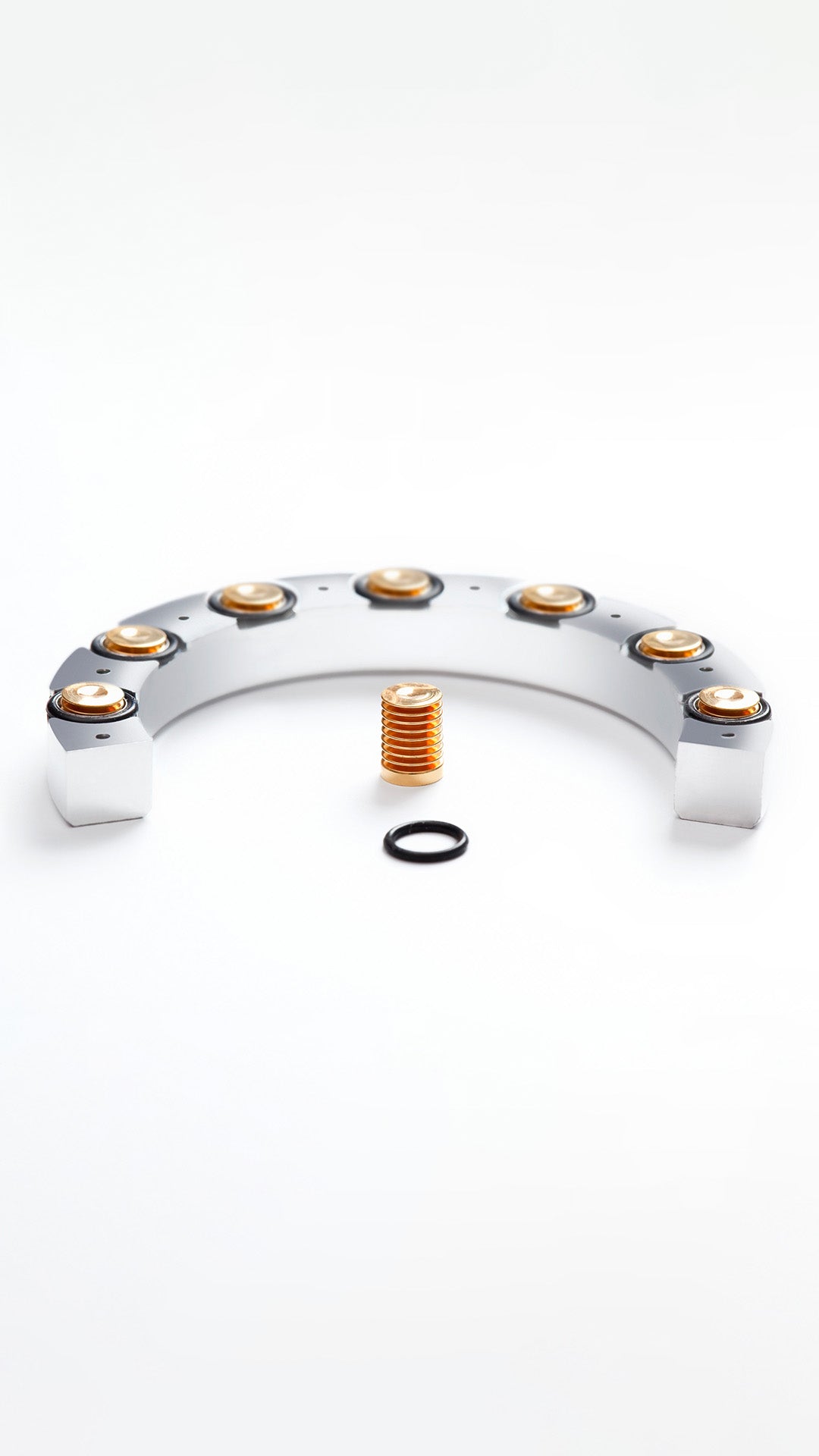Ressence watches mechanical bellows used on oil-filled watches to compensate for oil volume fluctuation in the upper part of the dial, with gold and silver parts on a white background, vertical image.