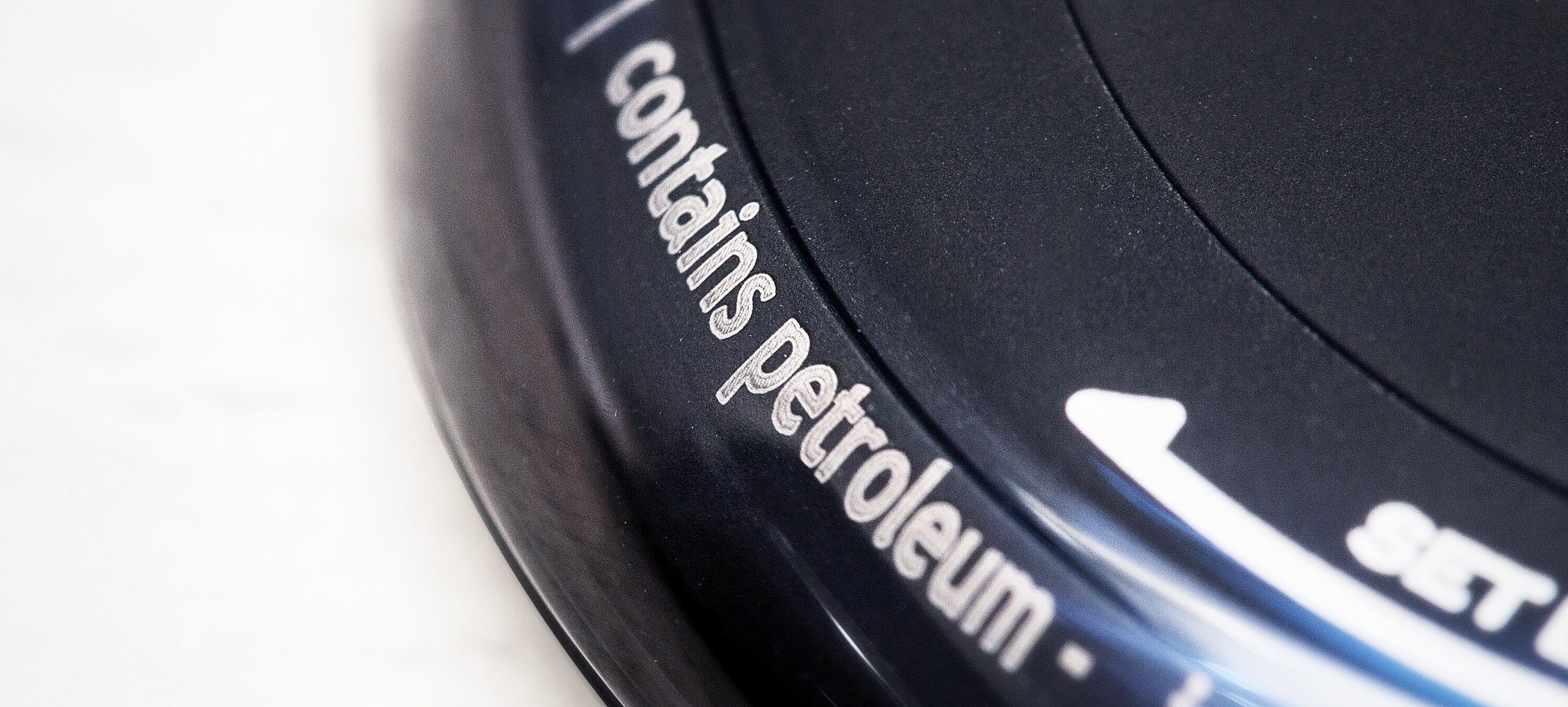 Close up view of a Ressence oil filled dial, showing the indication "contains petroleum" as seen on the side of the watch's dial.
