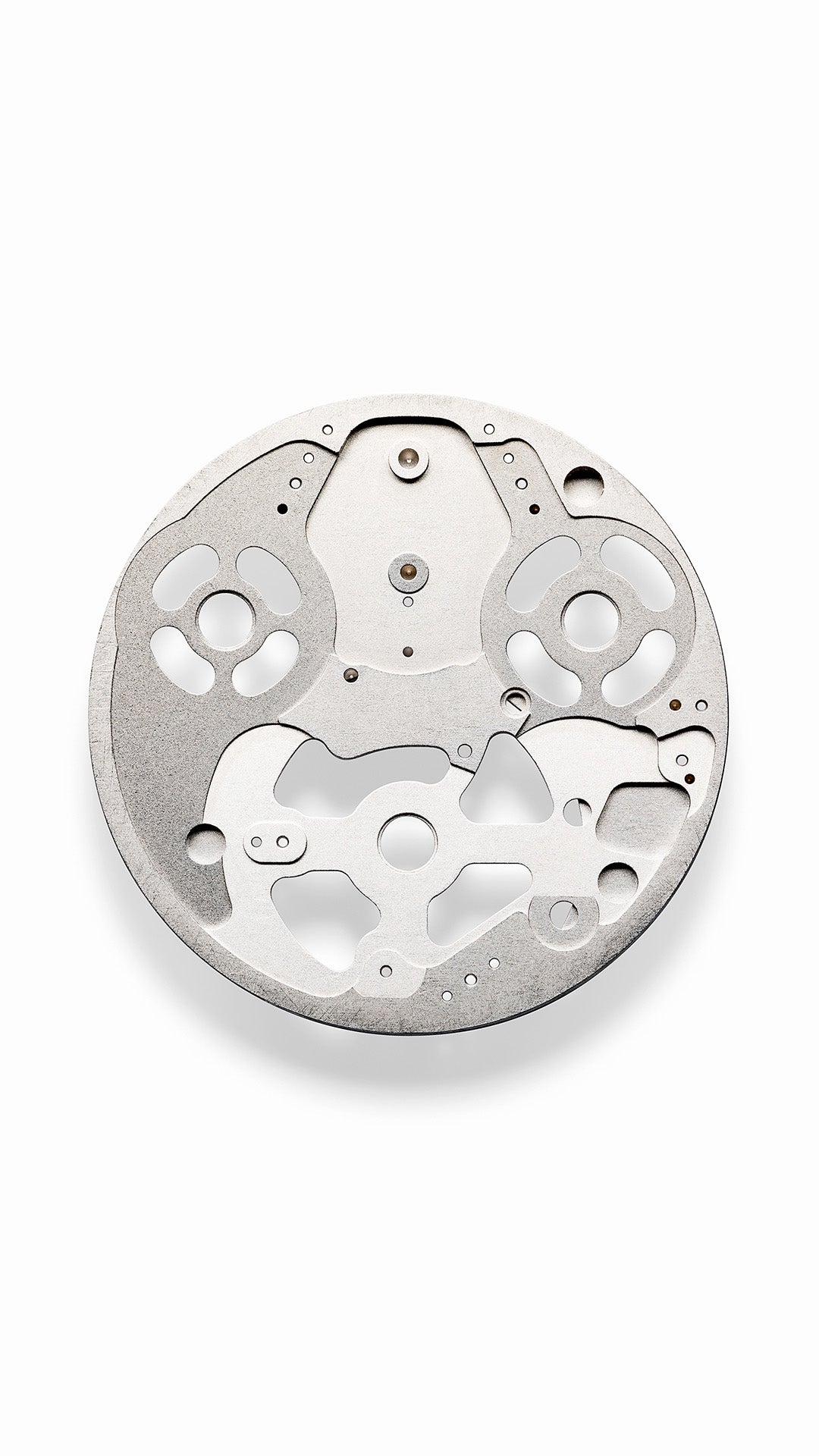 Vertical image of a Ressence ROCS (Ressence Orbital Convex System) internal disc module on a white background