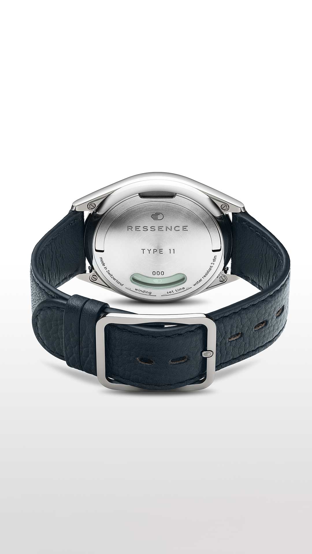 Vertical view of the caseback of a Ressence TYPE 11 contemporary watch with blue leather strap and titanium case on a white background