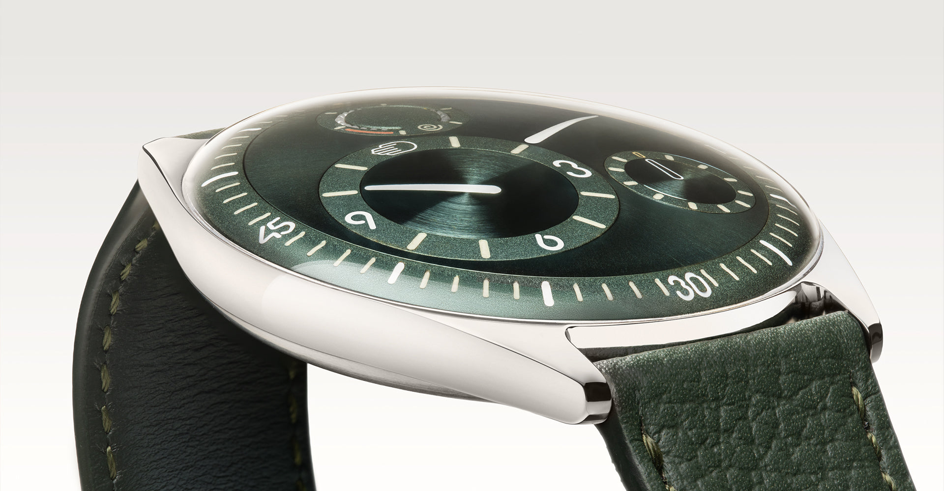 Ressence TYPE 11 Pine, a contemporary watch with a green dial and green leather strap, shown dial-up on the side