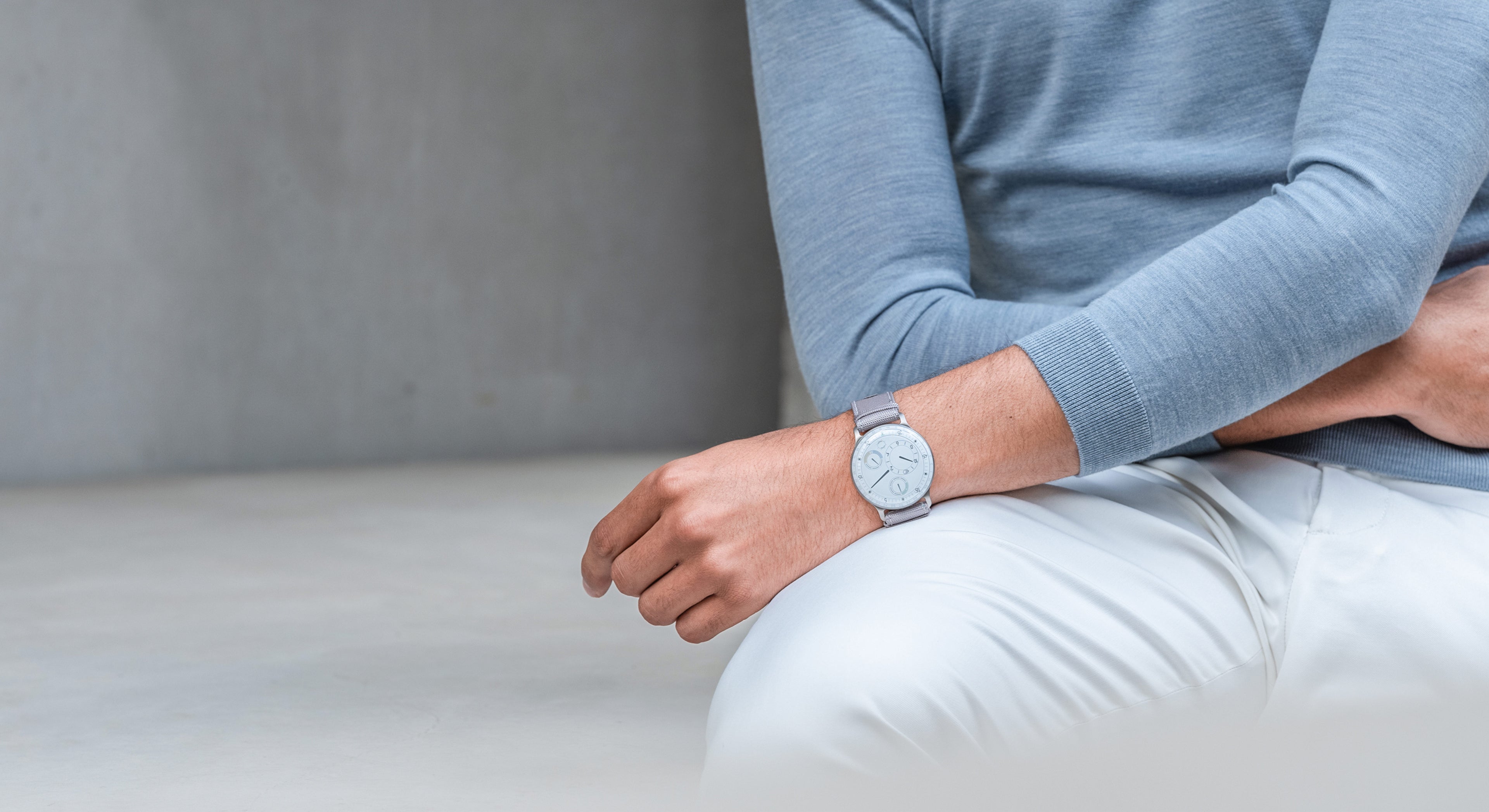 Man sitting wearing a Ressence TYPE 3 White, the ultimate oil-filled high end mechanical watch
