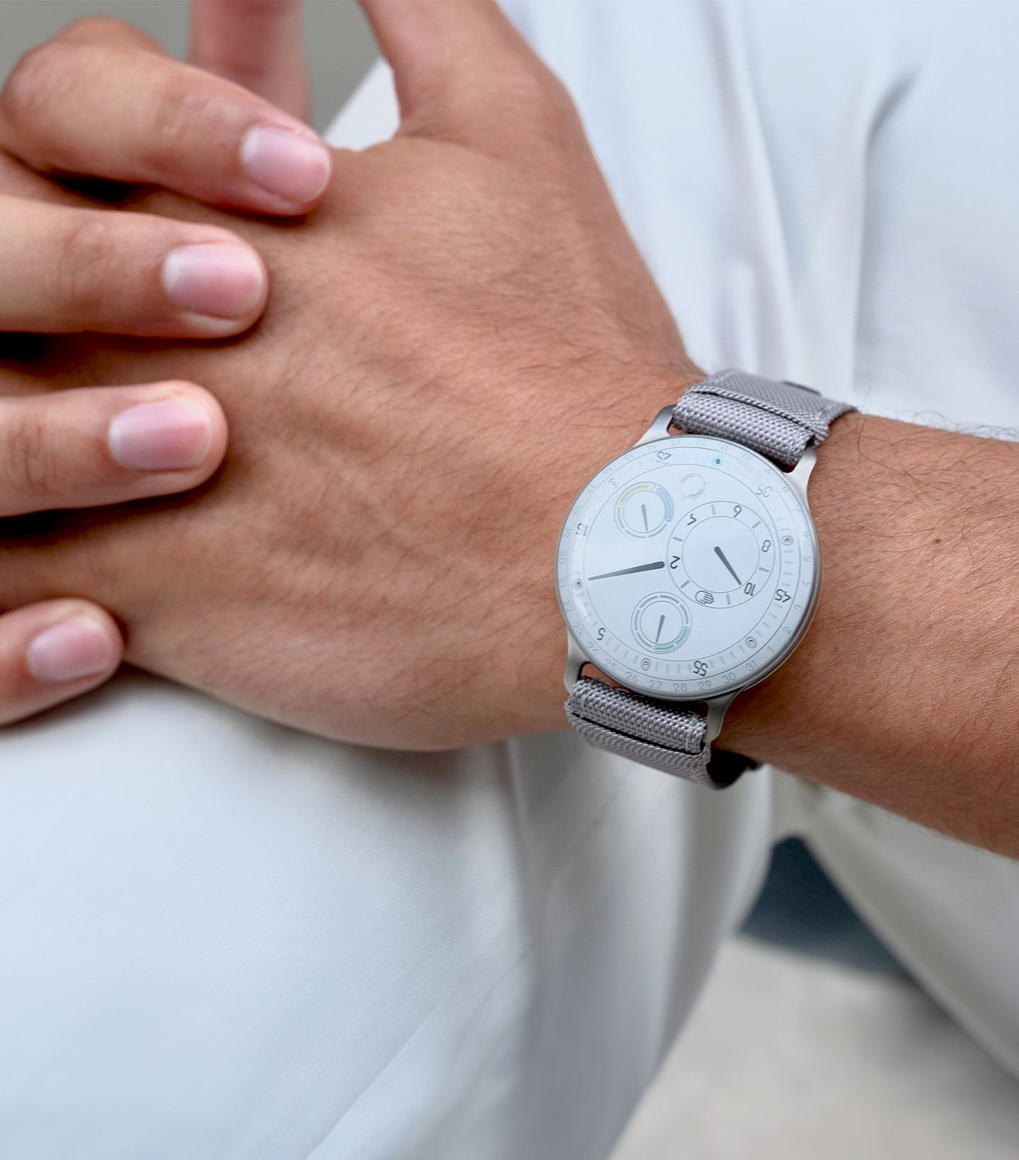 Ressence TYPE 3 White, the ultimate oil-filled high end mechanical watch, shown on a man's wrist. Vertical image.