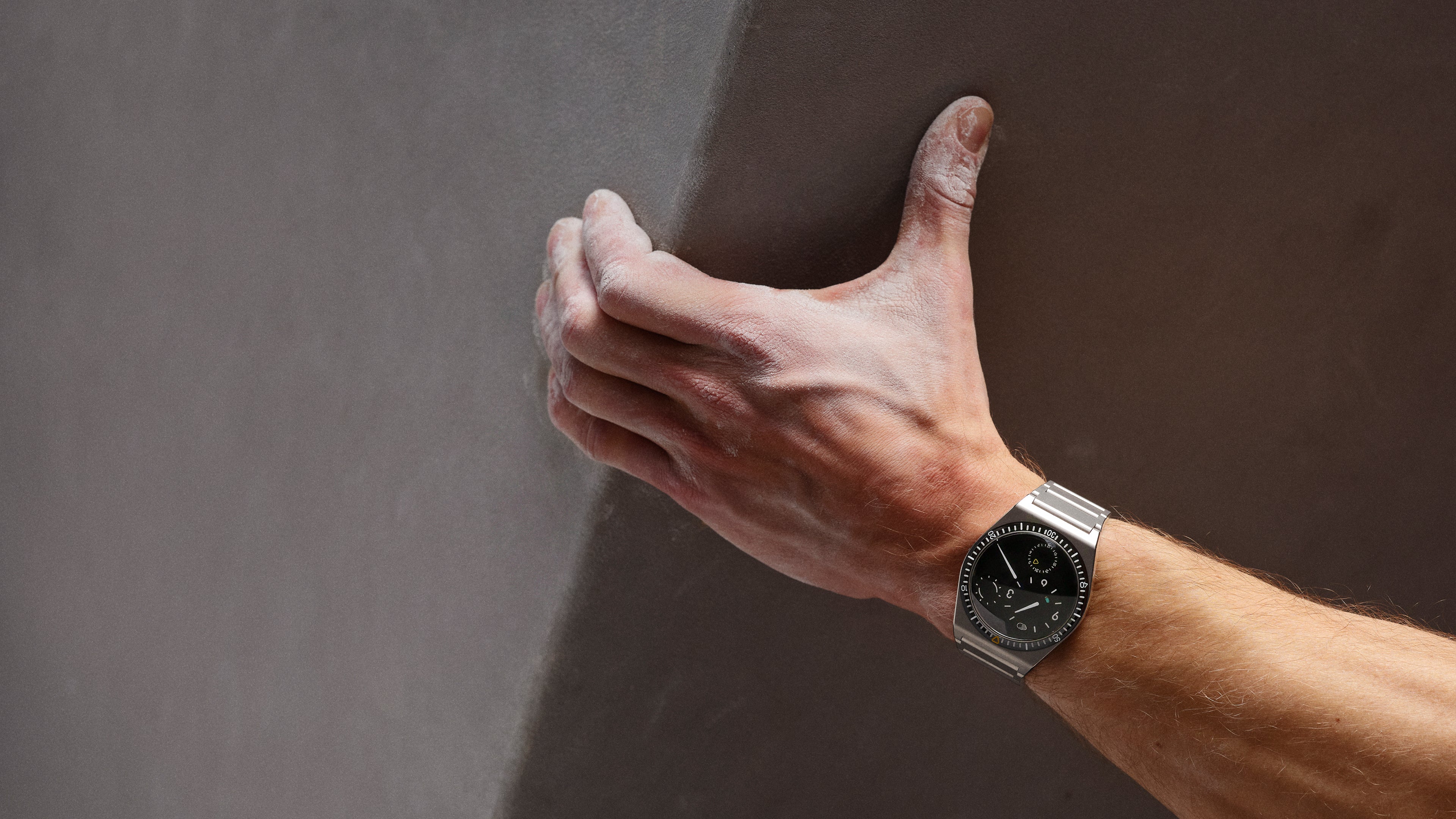 Ressence TYPE 7 Black, a titanium GMT watch, shown on the wrist of a man
