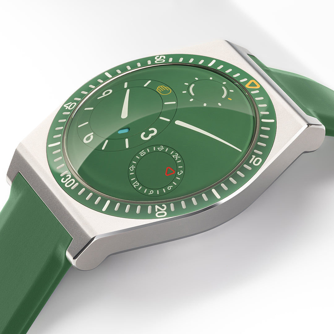 Ressence TYPE 7 Cactus, a titanium GMT watch with a green dial, shown from the side. vertical shot on white background