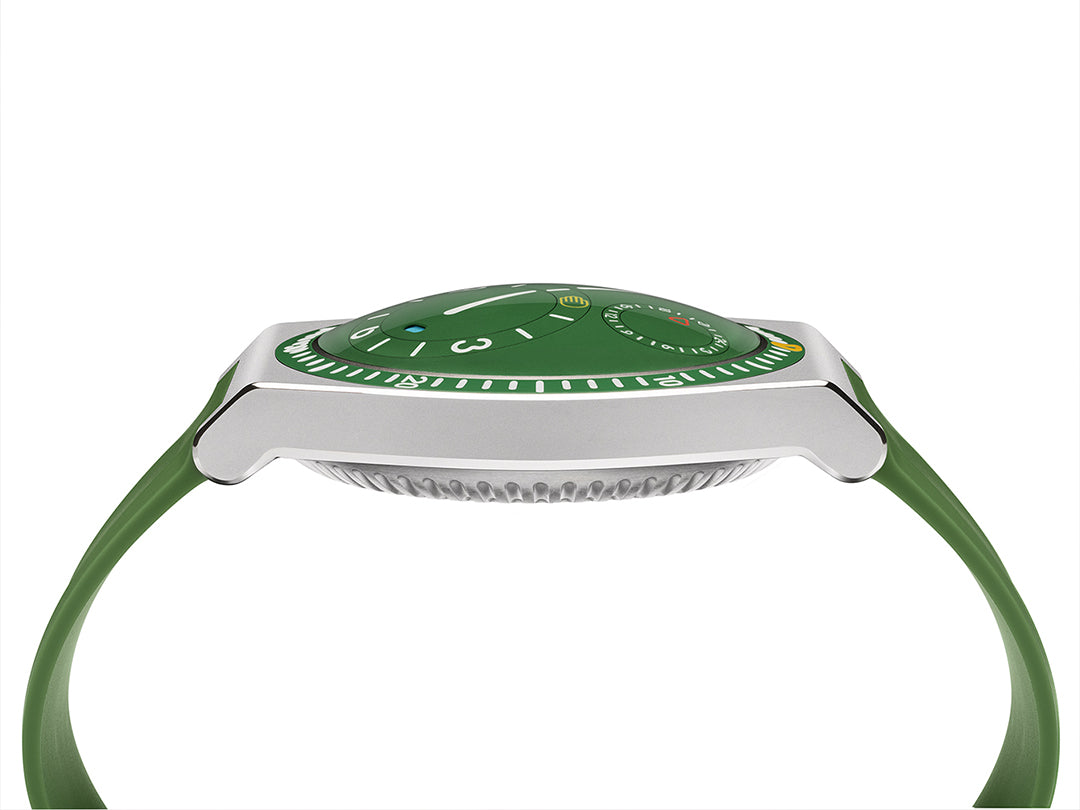 Mobile image of a cactus green Ressence TYPE 7 titanium GMT sport-chic watch shown dial up from the side, with a green rubber strap on a white background