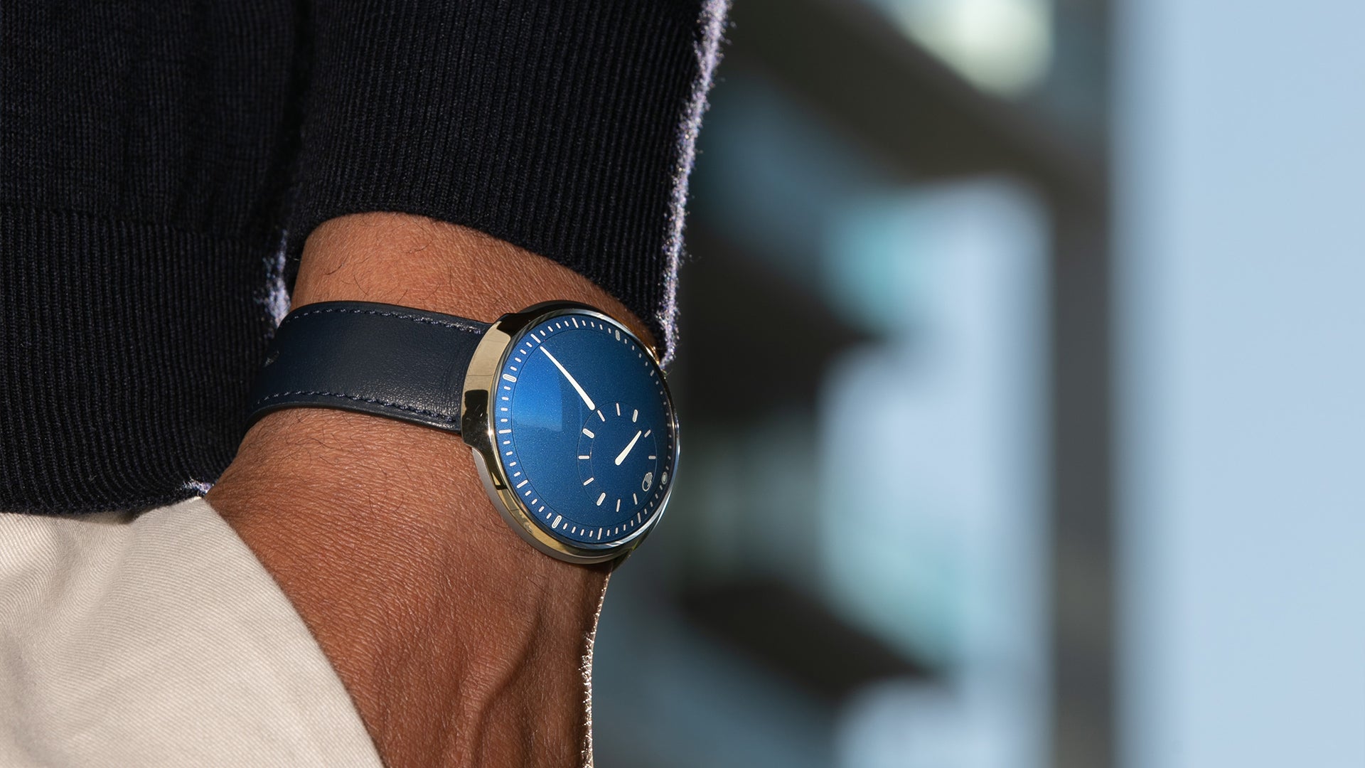 Man wearing a Ressence TYPE 8 Cobalt Blue, a minimal design watch, shown 