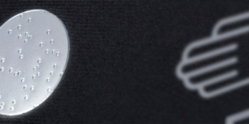 Mobile close up image of the bubble tag on a Ressence Warranty card